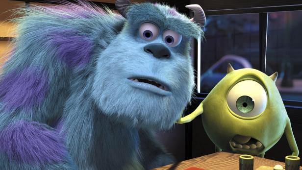 Sully und Mike Glotzkowski aus dem Film „Die Monster AG“ sitzen an einem Tisch.