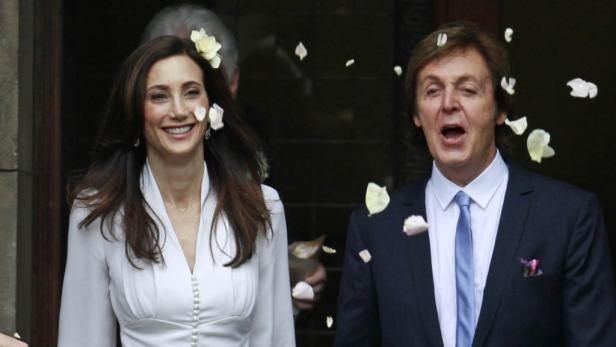 Paul McCartney und Nancy Shevell werden mit Blütenblättern beworfen.