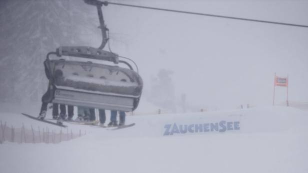 Ein Sessellift mit Skifahrern im verschneiten Skigebiet Zauchensee.