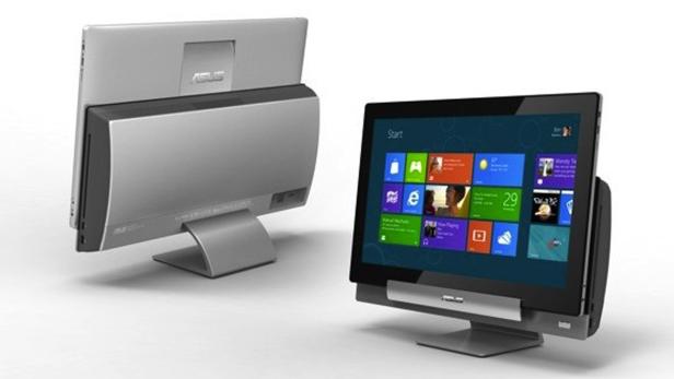 Zwei silberne All-in-One-Computer von Asus stehen auf einem weißen Tisch.