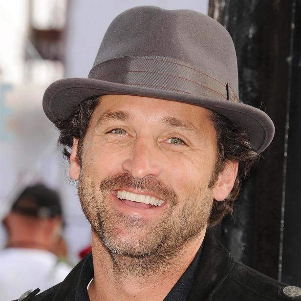 Patrick Dempsey lächelt und trägt einen grauen Hut.