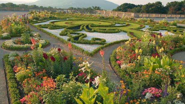 Ein formaler Garten mit Blumenbeeten und kunstvollen Rasenflächen.