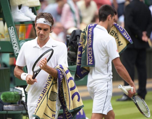 Roger Federer und Novak Đoković verlassen den Tennisplatz in Wimbledon.