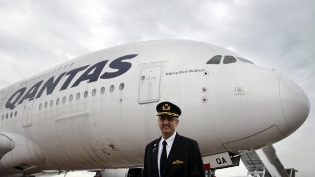 Ein Pilot steht vor einem Qantas-Flugzeug vom Typ Airbus A380 namens „Nancy-Bird Walton“.