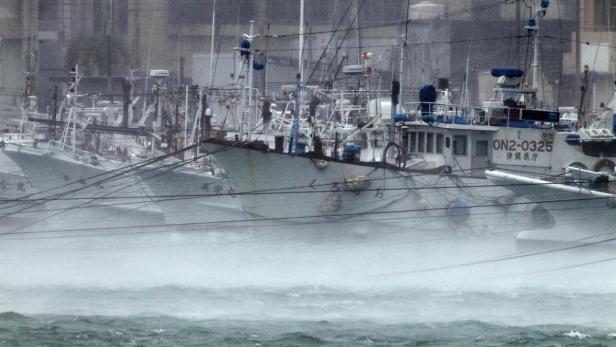 Mehrere Fischerboote liegen während eines Sturms im Hafen.