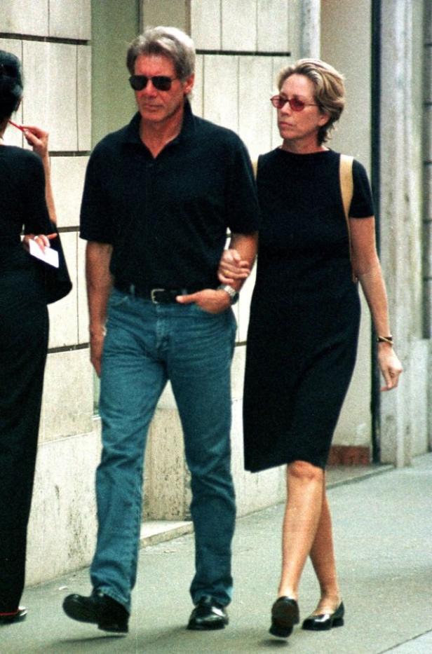 Harrison Ford und seine Frau Calista Flockhart gehen Arm in Arm die Straße entlang.