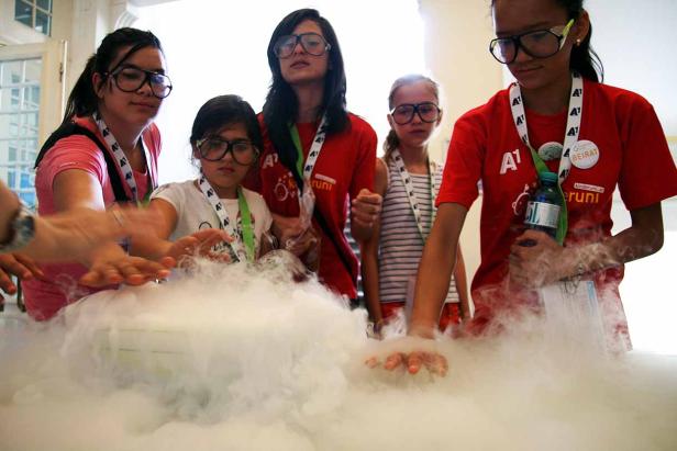 Eine Gruppe von Kindern experimentiert mit Trockeneis und Schutzbrillen.