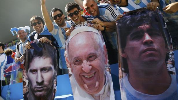 Argentinische Fans halten Pappfiguren von Messi, Papst Franziskus und Maradona hoch.