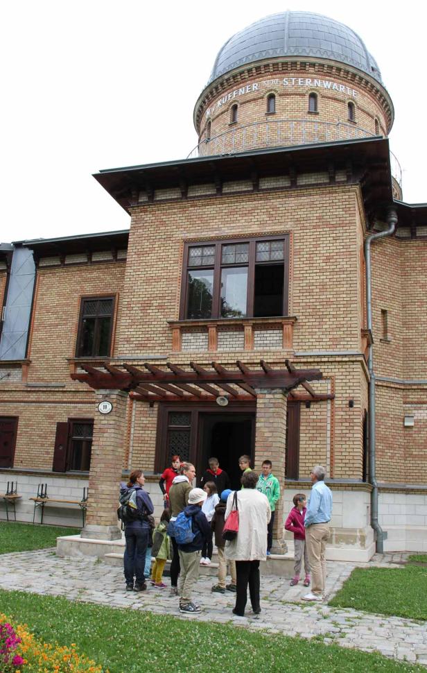 Eine Gruppe von Menschen steht vor dem Eingang der Kuffner-Sternwarte in Wien.
