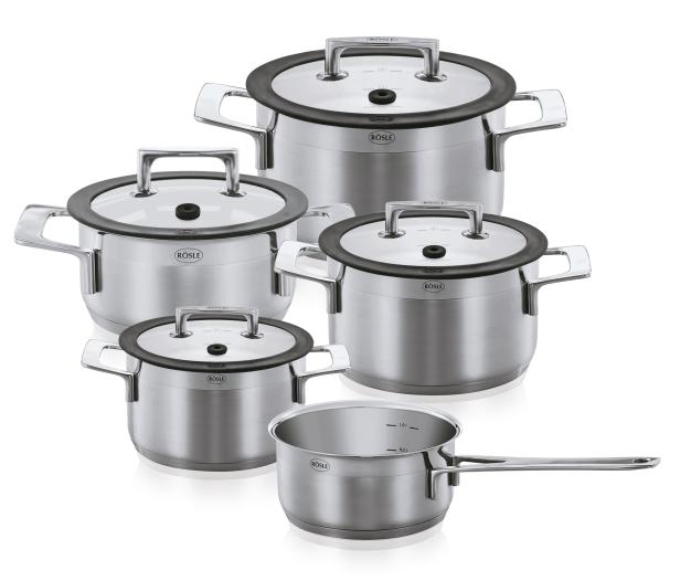 Ein Set aus fünf Edelstahltöpfen der Marke Rösle mit Glasdeckeln.