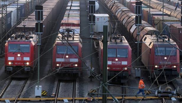 File photo of worker passes parked locomotives in Deutsche Lokführer legen Personenverkehr lahm