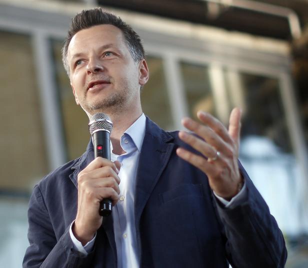 Gewerkschafter Hebenstreit Ein Mann spricht in ein Mikrofon und gestikuliert mit der Hand.