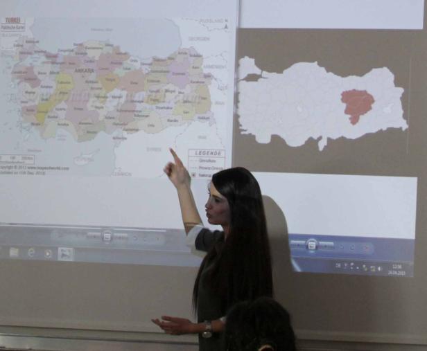 Eine Frau präsentiert eine politische Karte der Türkei auf einem Bildschirm.