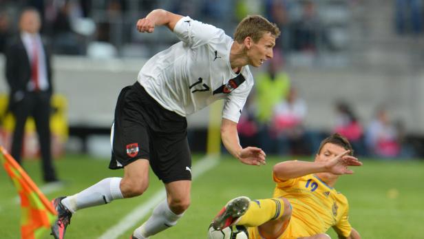 Ein österreichischer Fußballspieler im Zweikampf mit einem ukrainischen Spieler.