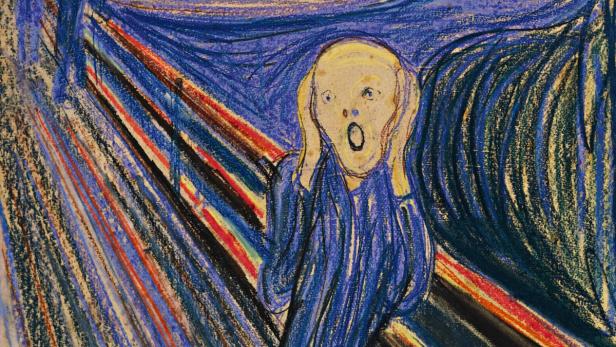 Eine Person mit aufgerissenem Mund hält sich die Hände an die Wangen.