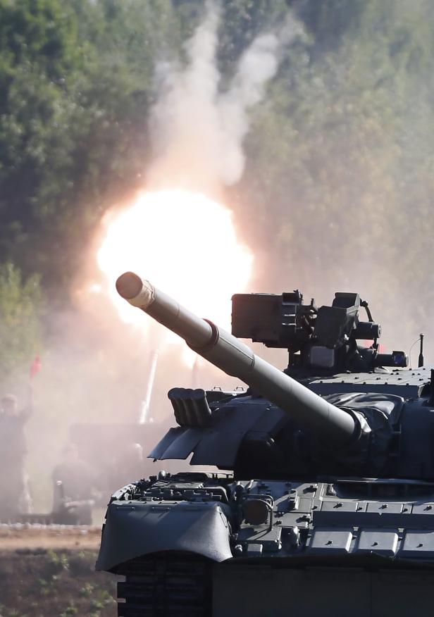Ein Panzer feuert mit einer großen Rauchwolke im Hintergrund.