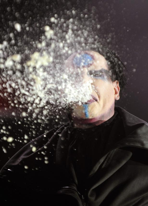 Marilyn Manson wird mit einer Flüssigkeit im Gesicht getroffen.