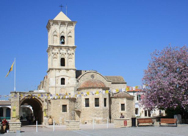Die Lazarus-Kirche in Larnaka, Zypern, mit einem blühenden Baum im Vordergrund.