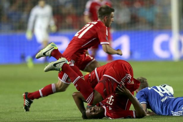 Ein Fußballspieler des FC Bayern liegt nach einem Foul auf dem Rasen.