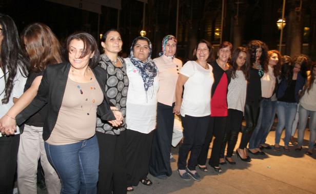 Eine Gruppe von Frauen hält Händchen und steht nebeneinander.