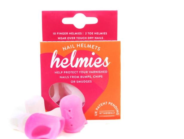 Eine Packung „Helmies“ Nagelschutzkappen in Rosa und Weiß.