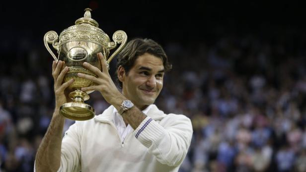Roger Federer hält die Trophäe nach seinem Sieg in Wimbledon hoch.