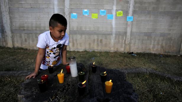 Candles are lit for victims after a fire broke out