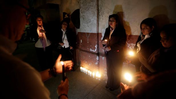 Candles are lit during a vigil for victims after a