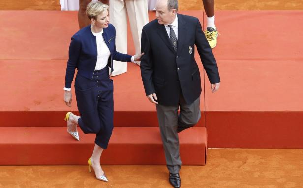 Fürstin Charlène und Fürst Albert gehen eine Treppe hinunter.