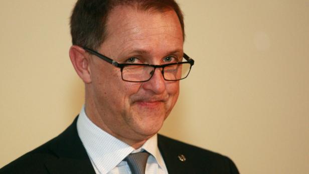 Thomas Sedran führt Opel interimistisch Ein Mann mit Brille, Anzug und Krawatte lächelt in die Kamera.