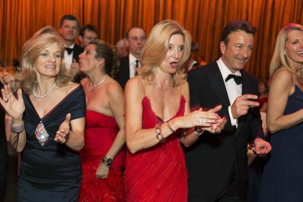 Mehrere elegant gekleidete Personen tanzen auf einer Veranstaltung.