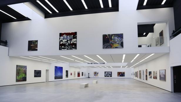 Ein Ausstellungsraum mit mehreren Gemälden an den Wänden.