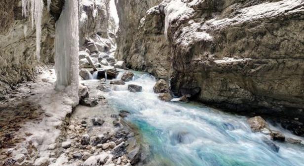 Die Partnachklamm im Winter mit Eis und fließendem Wasser.