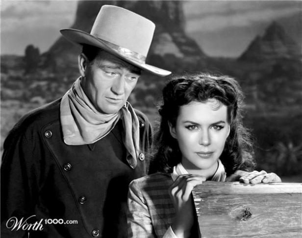 John Wayne und eine Frau stehen vor einer Westernkulisse.
