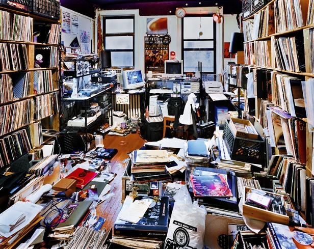 Ein chaotischer Raum voller Schallplatten, Elektronik und anderer Gegenstände.