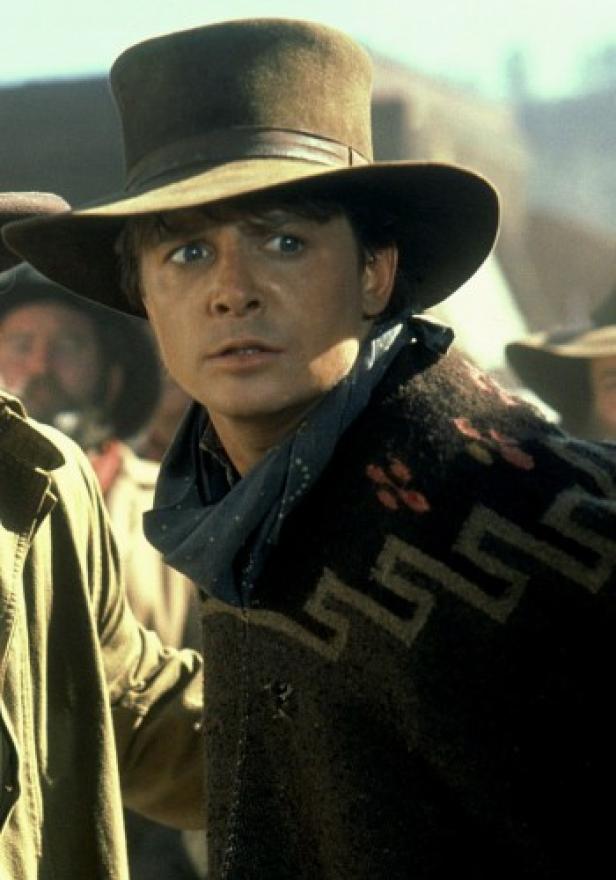 Michael J. Fox als Marty McFly in „Zurück in die Zukunft III“ mit Hut und Poncho.