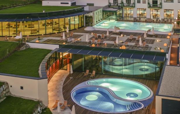 Ein luxuriöses Resort mit mehreren Pools und Liegebereichen im Freien.