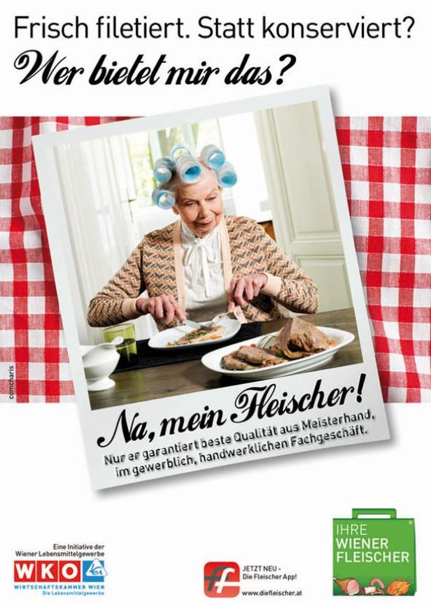Eine ältere Dame mit Lockenwicklern isst Fleisch am Tisch.