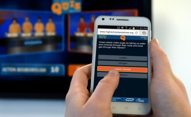 Eine Person nimmt mit einem Smartphone an einem Online-Quiz teil.