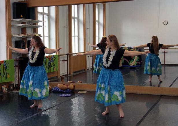 Mehrere Frauen tanzen Hula in einem Tanzstudio.