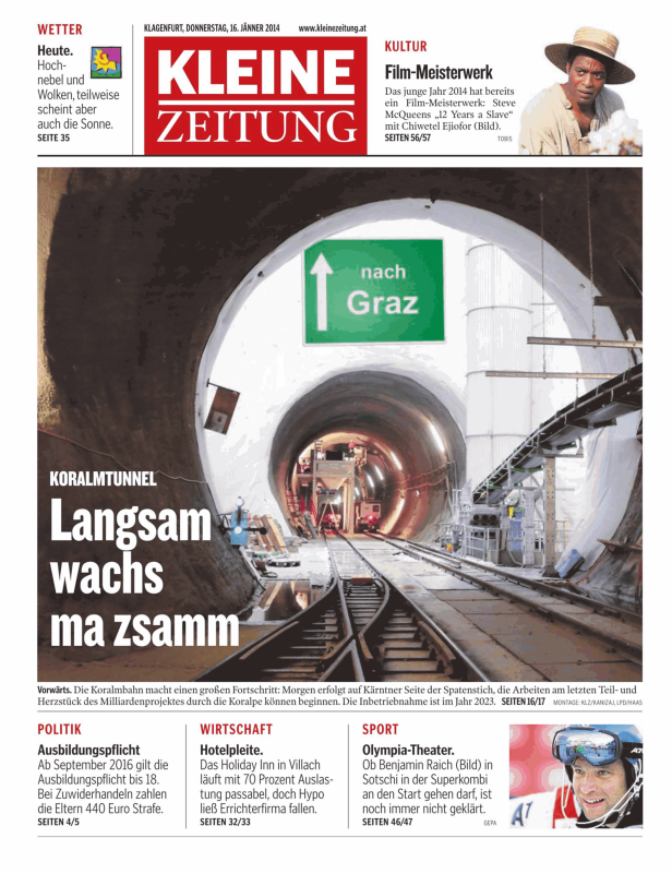 Blick in den Koralmtunnel mit Gleisen und einem Schild „nach Graz“.