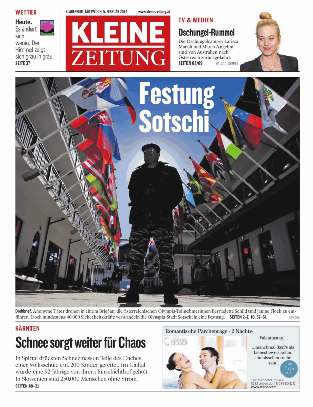 Ein Mann in Uniform steht vor einer Fassade, die mit Flaggen geschmückt ist.