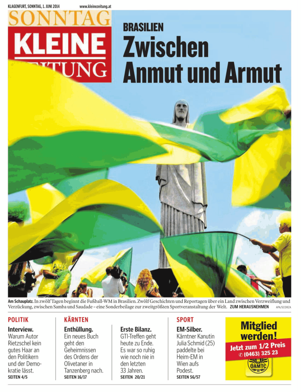 Die Christusstatue in Rio de Janeiro vor einer brasilianischen Flagge.