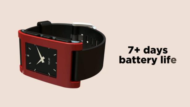 Eine rote Smartwatch mit schwarzem Armband zeigt „Di 27“ auf dem Display.