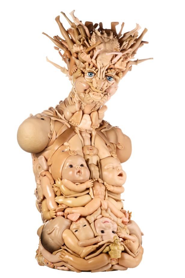 Eine Skulptur, die aus Puppenteilen zusammengesetzt ist und eine bizarre, humanoide Figur darstellt.