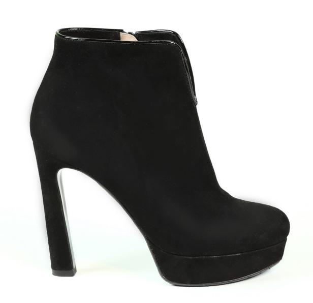 Ein schwarzer Wildleder-Stiefelette mit hohem Absatz und Plateausohle.