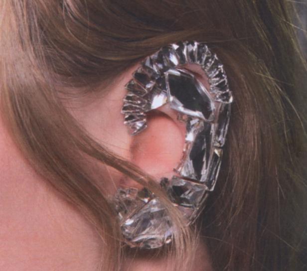 … Ein Ohr mit einem großen, auffälligen Ohrschmuck aus glitzernden Steinen.