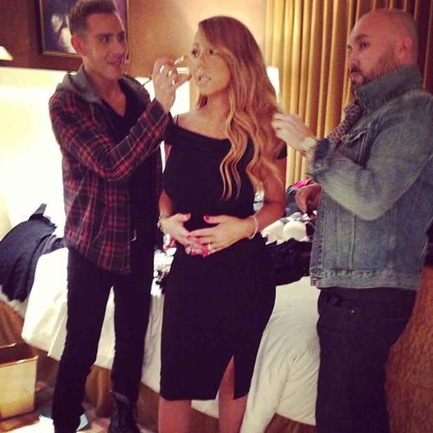 Mariah Carey wird von zwei Personen für ein Fotoshooting vorbereitet.