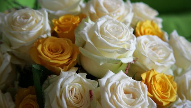 Ein Arrangement aus weißen und gelben Rosen.