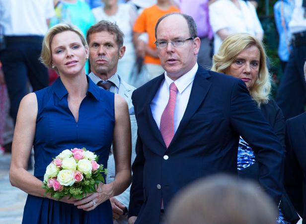 Fürstin Charlène mit einem Blumenstrauß neben Fürst Albert II..